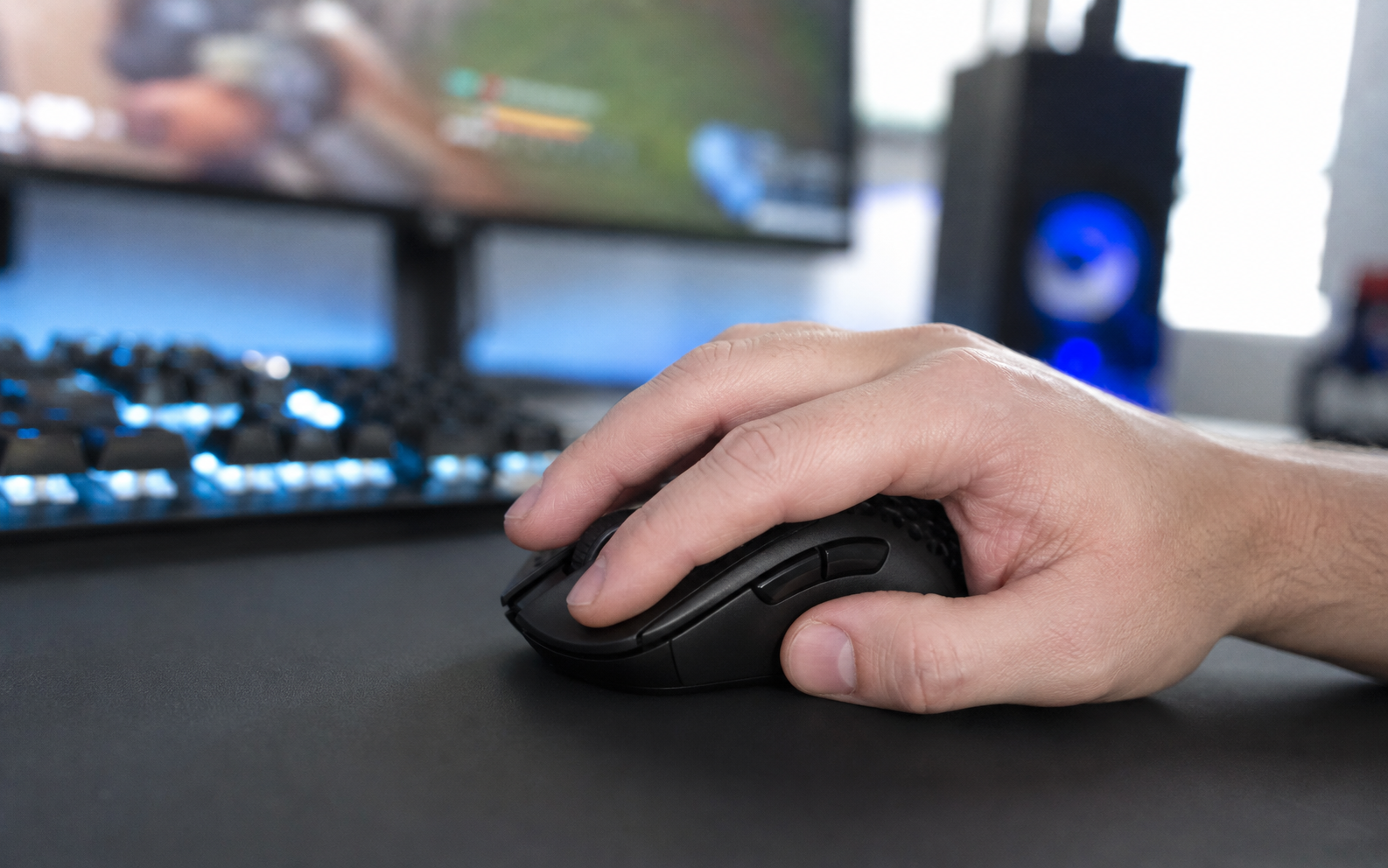 Natural hand grip on a black ultra-light wireless gaming mouse